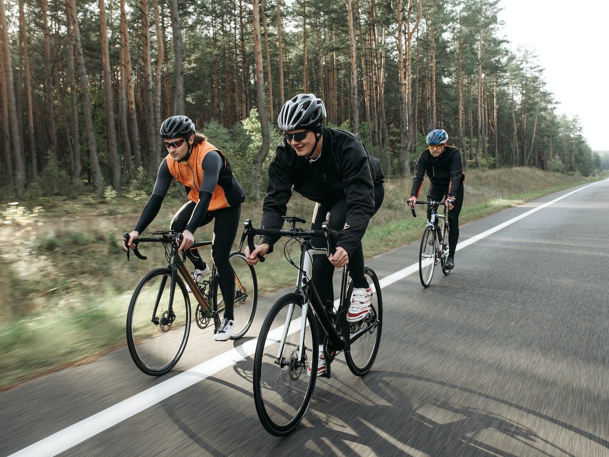 Image of three men on bikes.
